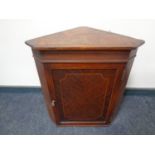 A 19th century inlaid mahogany hanging corner cupboard