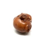 A carved hardwood netsuke - Two rats on a pot