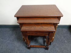 A nest of three stained beech tables