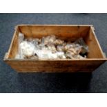 A vintage pine crate containing assorted wooden handles