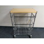 A pine topped metal three tier kitchen trolley with baskets