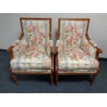 A pair of armchairs upholstered in a floral fabric