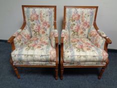 A pair of armchairs upholstered in a floral fabric