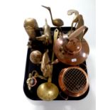 A tray containing assorted brass ornaments, telephone money box, ladle,