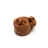 A carved hardwood netsuke - Turtle and frog in barrel