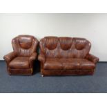 A brown leather three seater high back settee with matching armchair