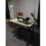 A Brother industrial treadle sewing machine in table