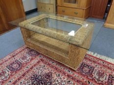 A bamboo and wicker glass topped conservatory table