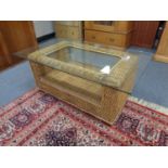 A bamboo and wicker glass topped conservatory table