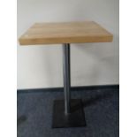 A pine topped poser bar table on metal pedestal