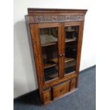 A 19th century oak double door bookcase fitted three drawers beneath