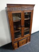 A 19th century oak double door bookcase fitted three drawers beneath