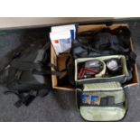 A box of video cameras in bags, camera bags,