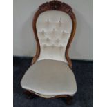 A 19th century mahogany nursing chair upholstered in a button dralon fabric