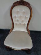 A 19th century mahogany nursing chair upholstered in a button dralon fabric