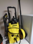 A Karcher K4 pressure washer with accessories