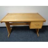A pine desk fitted two drawers