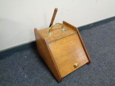 An Edwardian oak coal receiver with brass handles and shovel