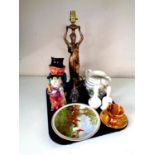 A tray of miscellany to include figural table lamp, character jugs, hand bells,