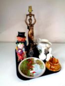A tray of miscellany to include figural table lamp, character jugs, hand bells,