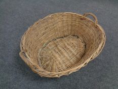 An antique wicker log basket