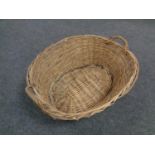 An antique wicker log basket