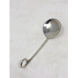 An Arts and Craft style silver spoon by A E Jones with a split ring and bead terminal.