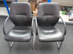 A pair of metal and faux leather office armchairs