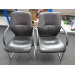 A pair of metal and faux leather office armchairs