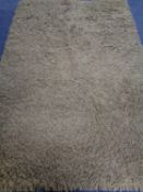 A contemporary olive shaggy pile rug