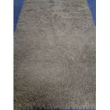 A contemporary olive shaggy pile rug