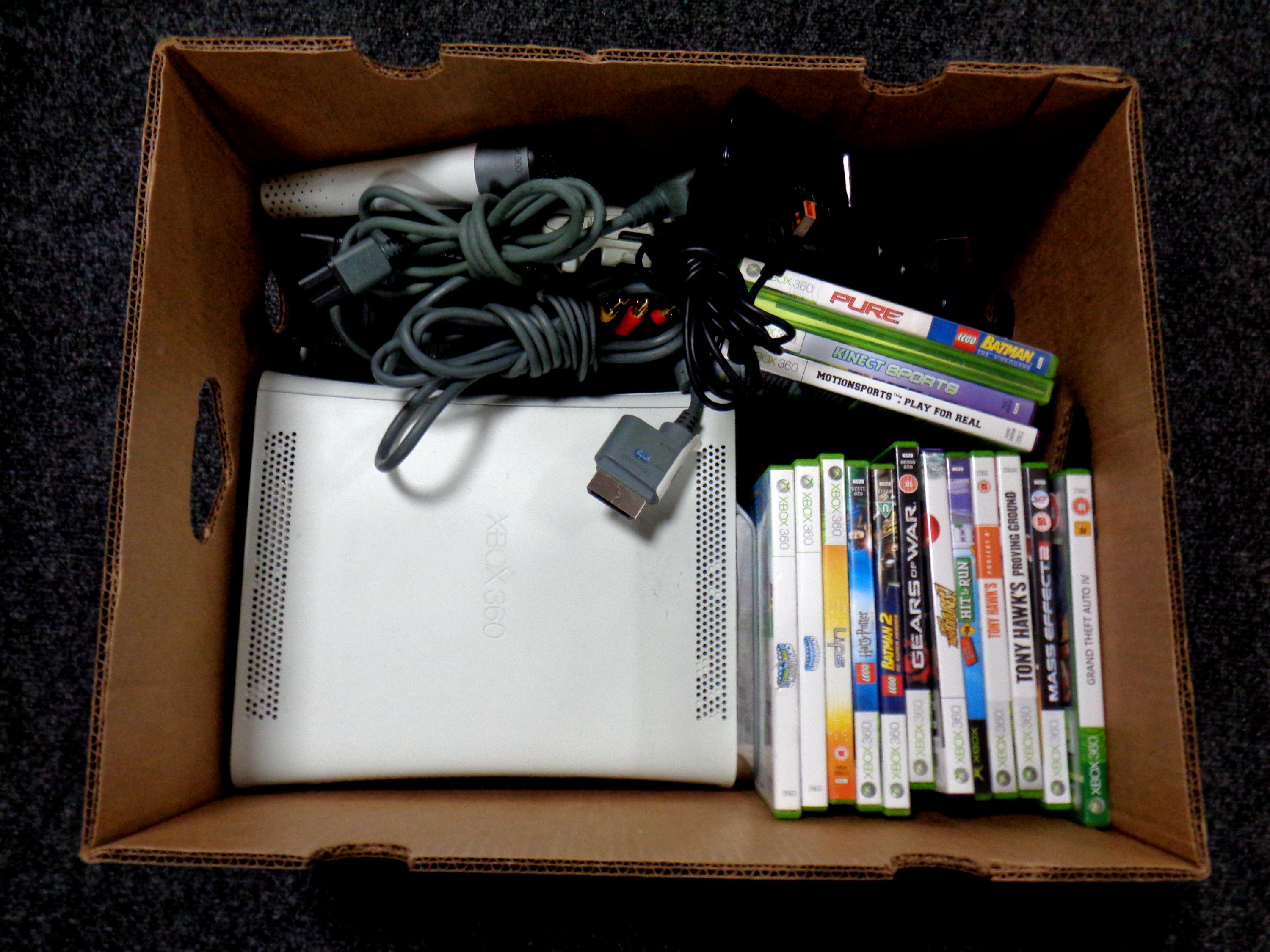 A box containing an X Box 360, leads,