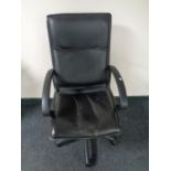 A faux leather swivel office armchair