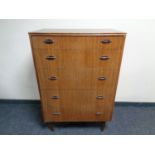 A mid 20th century teak five drawer chest