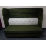 A contemporary high backed booth settee upholstered in a green and grey fabric