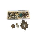 A box containing a quantity of military badges and buttons, British Transport Commission cap badge,