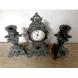 A miniature three piece pot metal clock garniture set