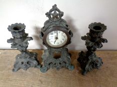 A miniature three piece pot metal clock garniture set