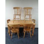 A pine farmhouse kitchen table together with a set of six chairs