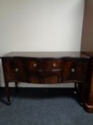 A Regency style serpentine fronted sideboard on raised legs