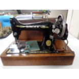 An early 20th century oak cased Singer hand sewing machine