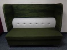 A contemporary high backed booth settee upholstered in a green and grey fabric