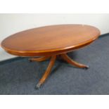 A Bradley Furniture reproduction oval yew wood pedestal coffee table