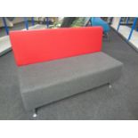 A pair of contemporary office settees upholstered in a red and grey fabric