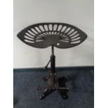 A cast iron tractor seat bar stool