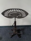 A cast iron tractor seat bar stool