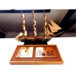 A wooden model of a 19th century clipper together with a 1970's teak framed copper and etched panel