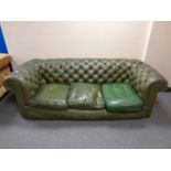 A green button leather Chesterfield three seater club settee (odd cushion)