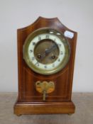 An Edwardian inlaid mahogany eight day mantel clock with brass and enamelled dial