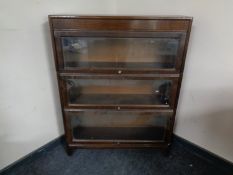 An early 20th century three tier oak stacking bookcase